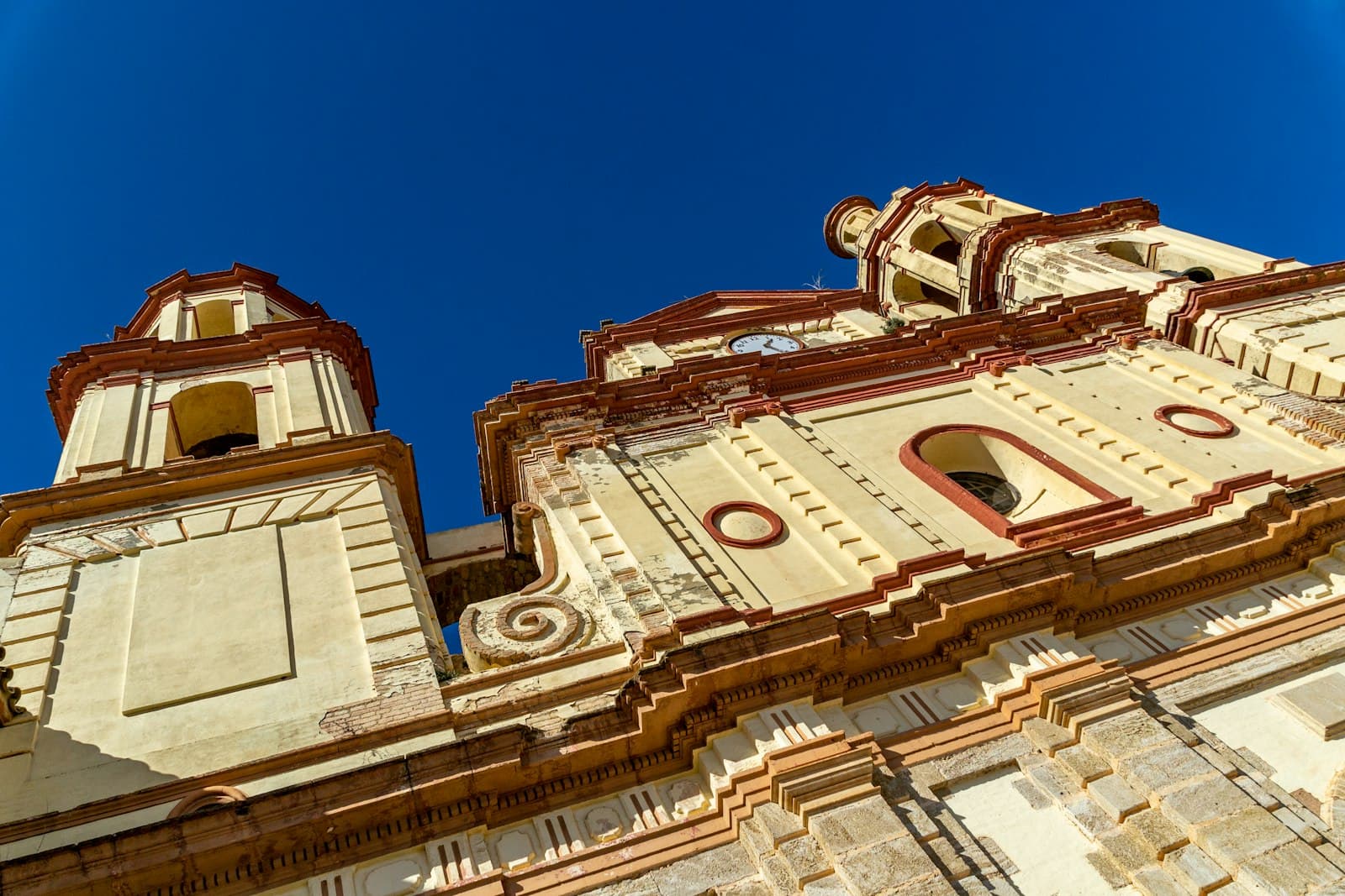 Olvera — a very tall building with two clocks on each of it's sides