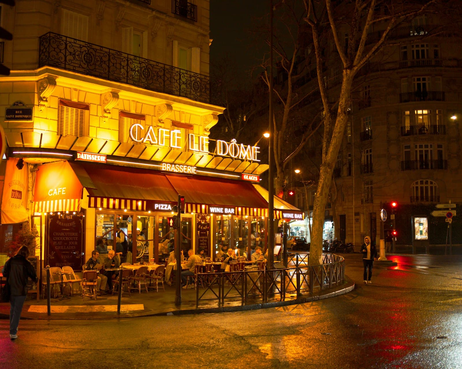 Orange — Café de dome, illuminated at night in paris.