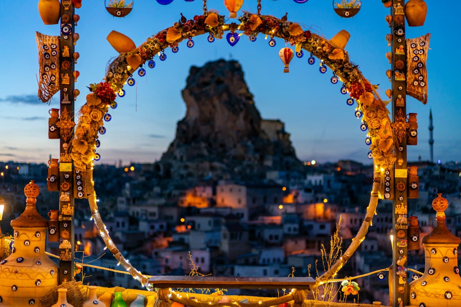 Ortahisar — a decorated archway with lights and decorations in front of a cityscape