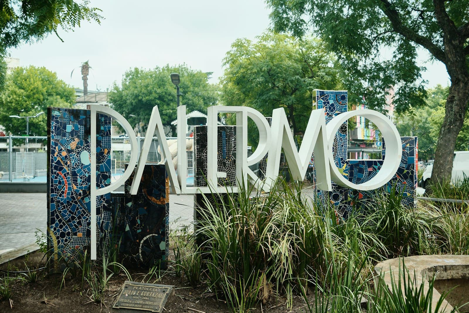 Palermo Soho Street Art — Large palermo sign with mosaic accents and greenery