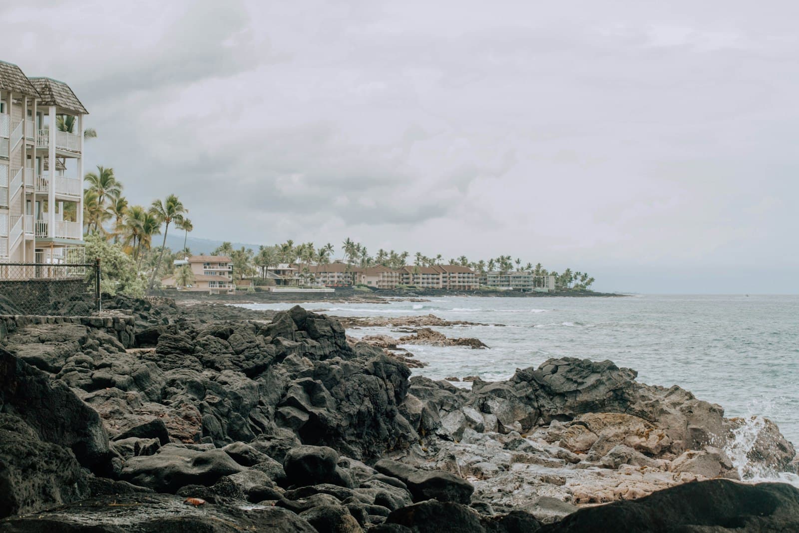 Palm Beach — a white building sitting on top of a rocky beach