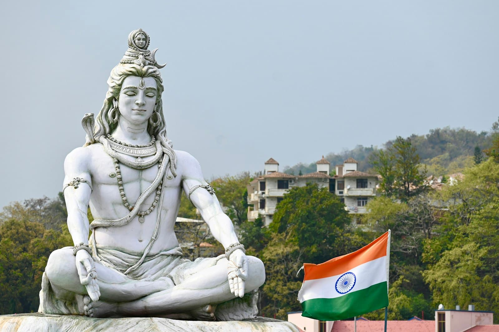 Panaji — a statue of a man sitting in a lotus position with a flag in front of