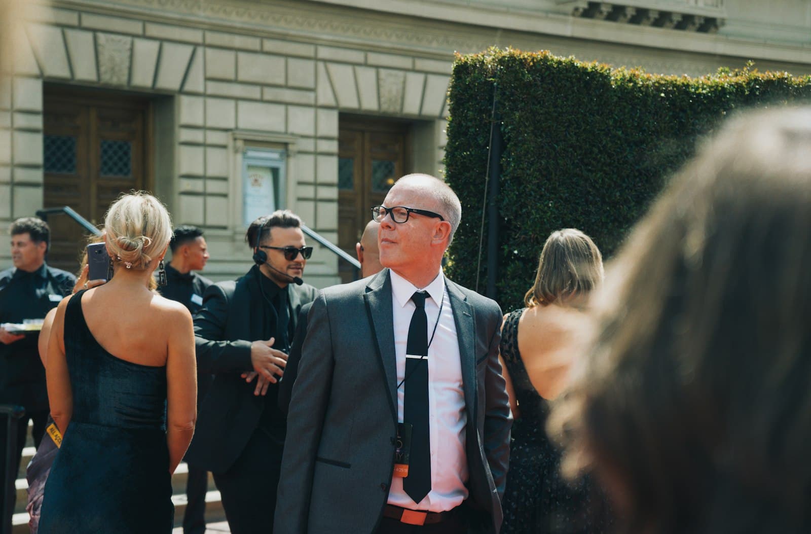 Pasadena — man in black suit standing beside woman in black sleeveless dress