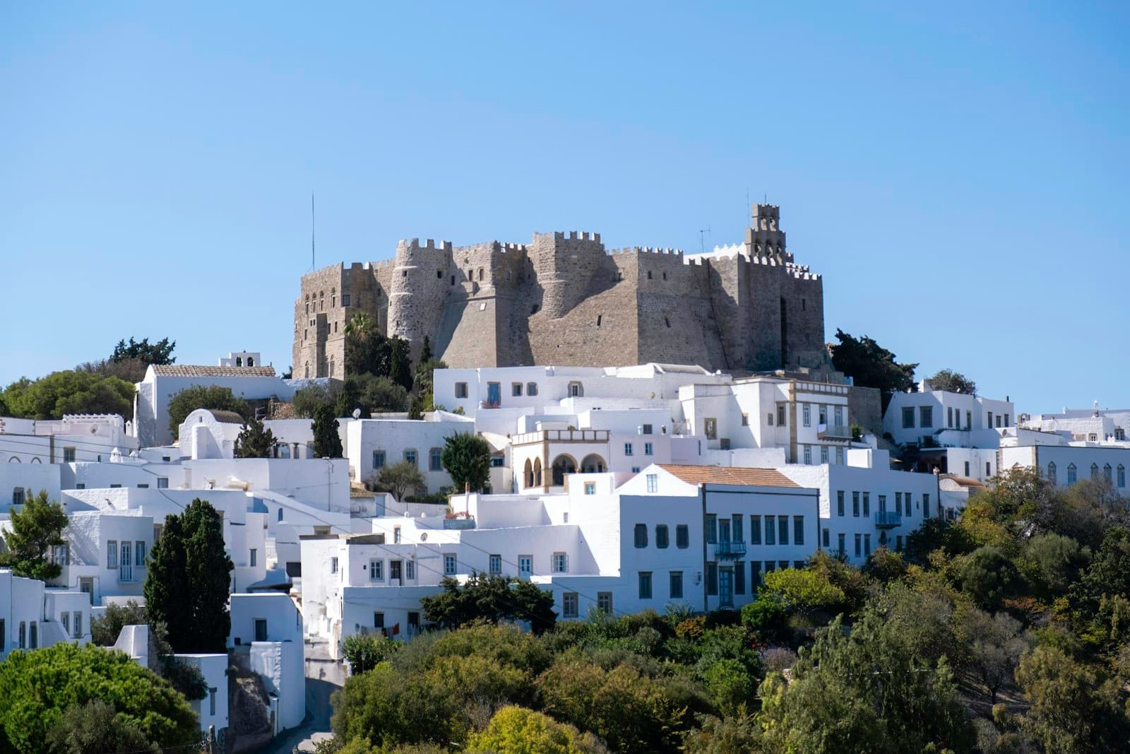 Patmos — A white city with a castle on top of it