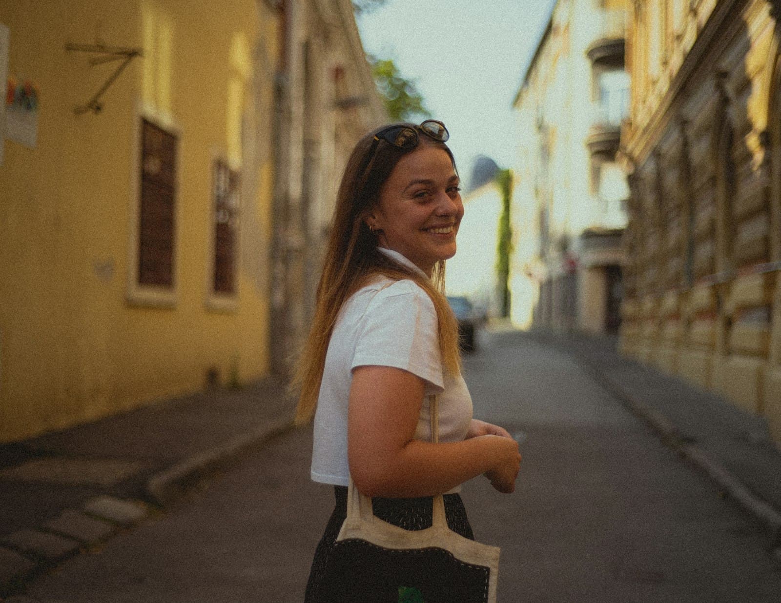 Pécs — a woman standing on a street