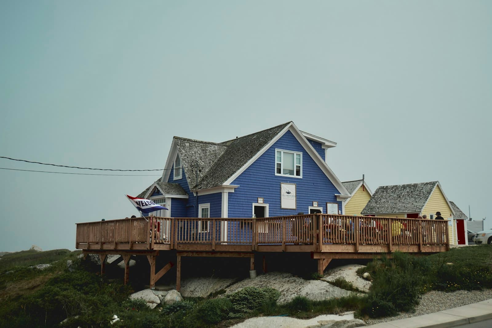 Peggy's Cove — a blue house sitting on top of a hill