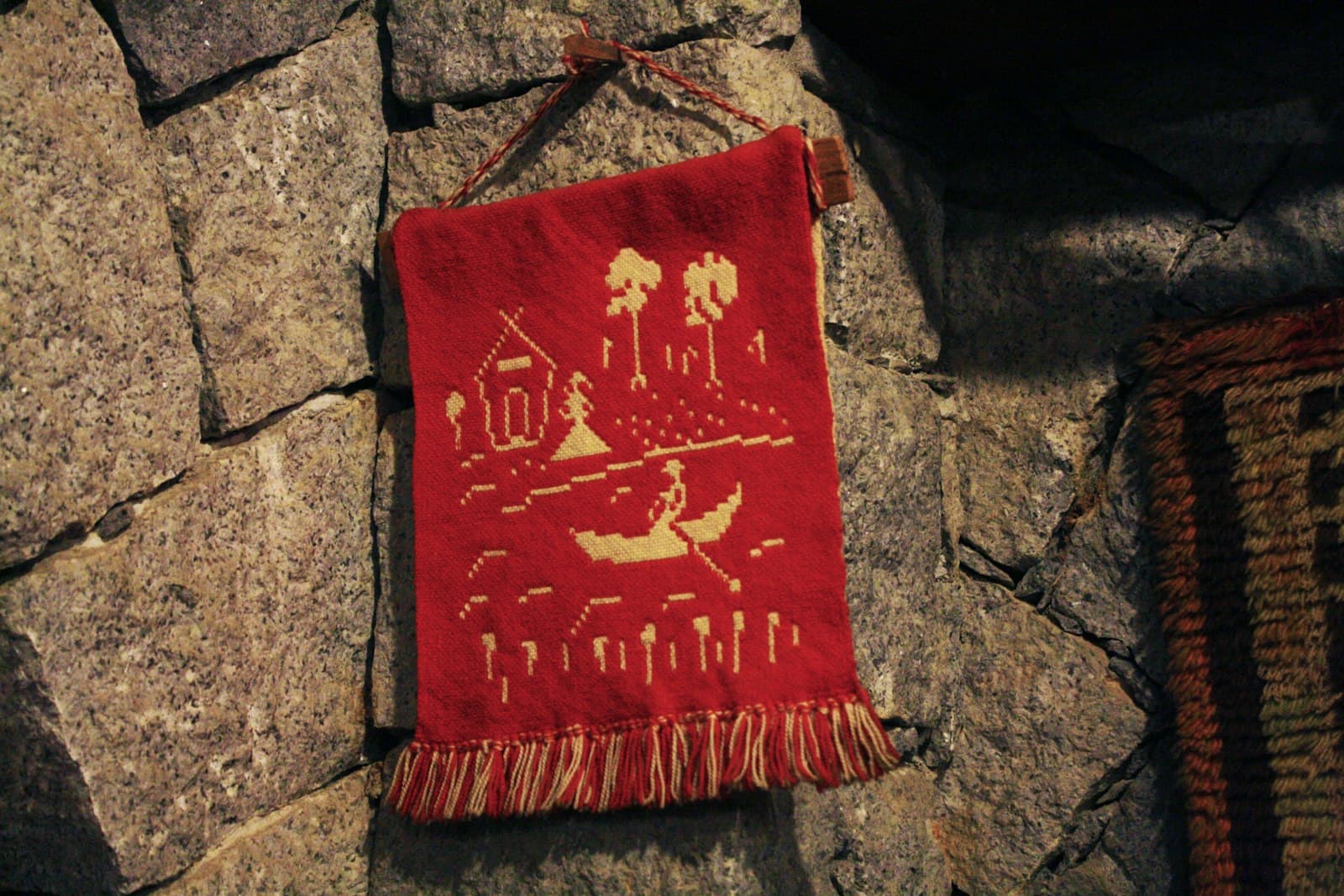 Penedo — a red and white pillow on a stone surface