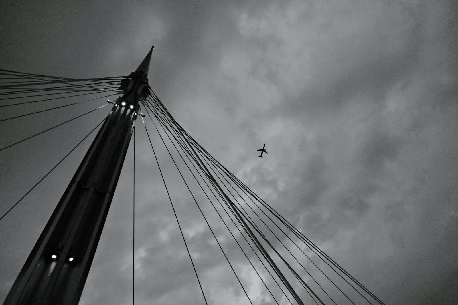 Pescara — a black and white photo of a plane flying in the sky