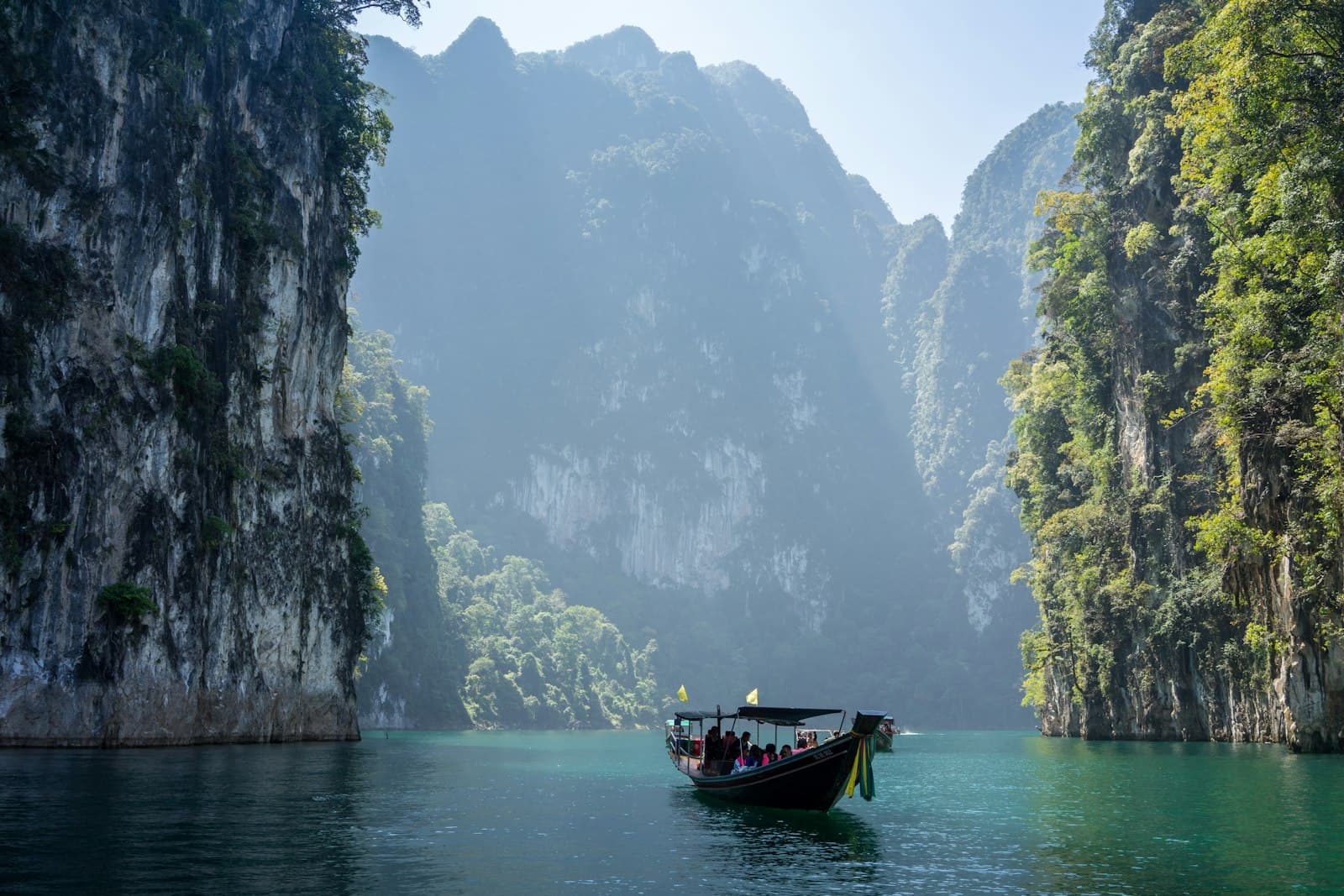 Phang Nga — white boat in between rocky mountains