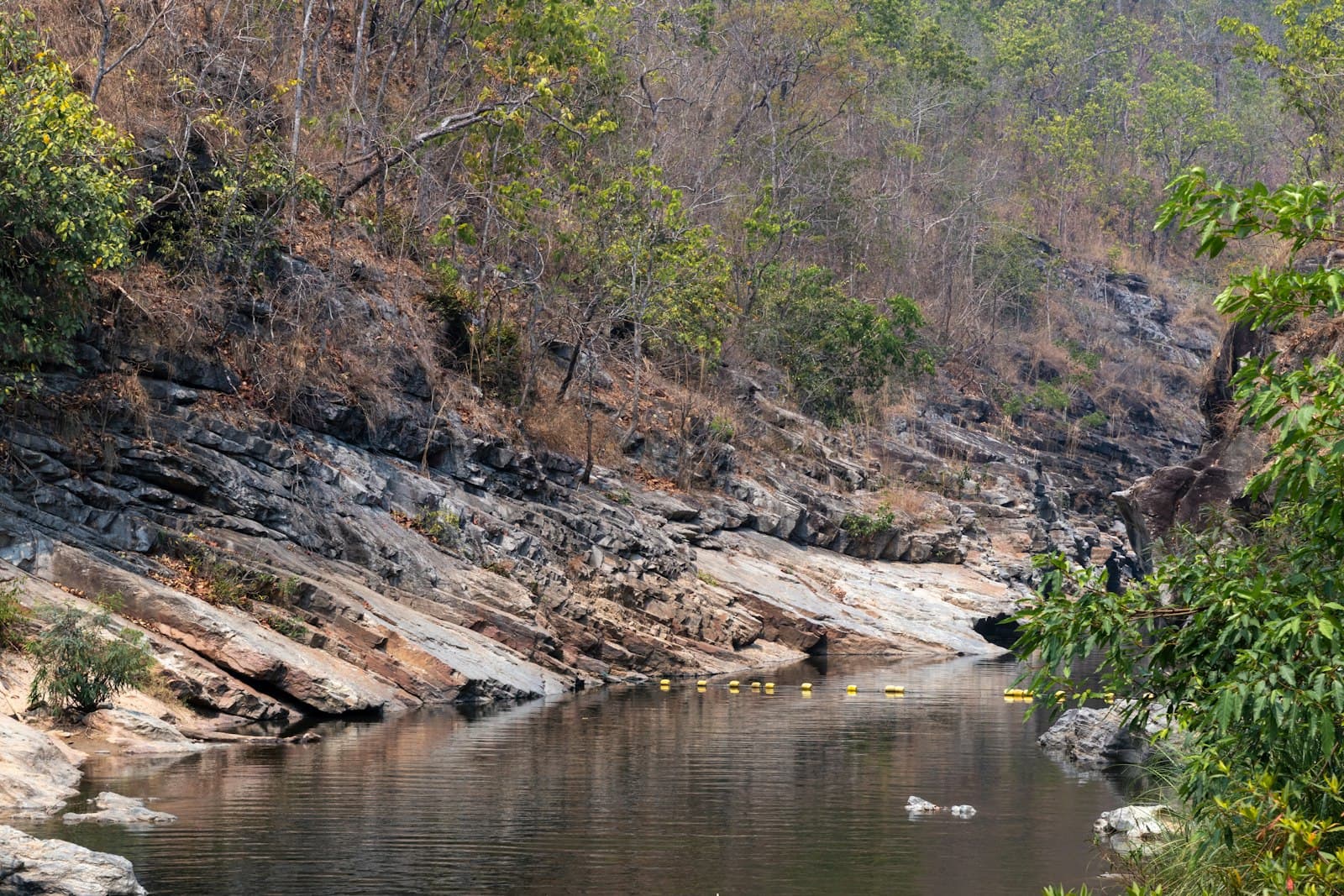 Phrae — a body of water surrounded by trees and rocks