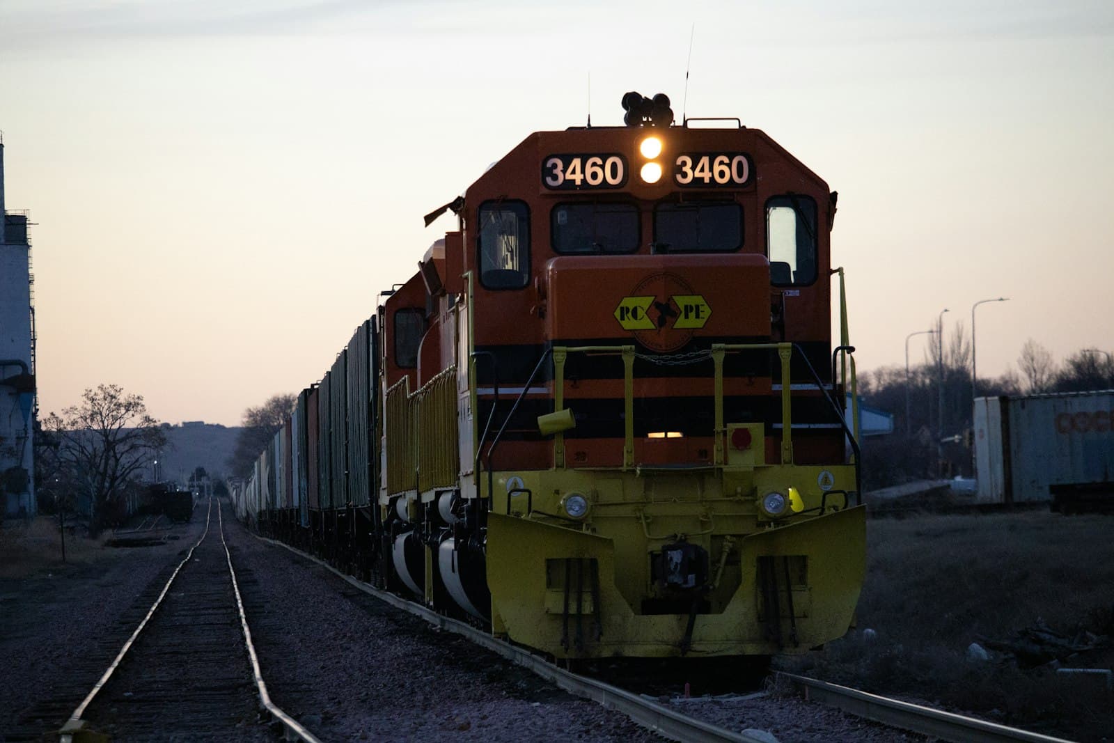 Pierre — yellow and black train on rail tracks during daytime