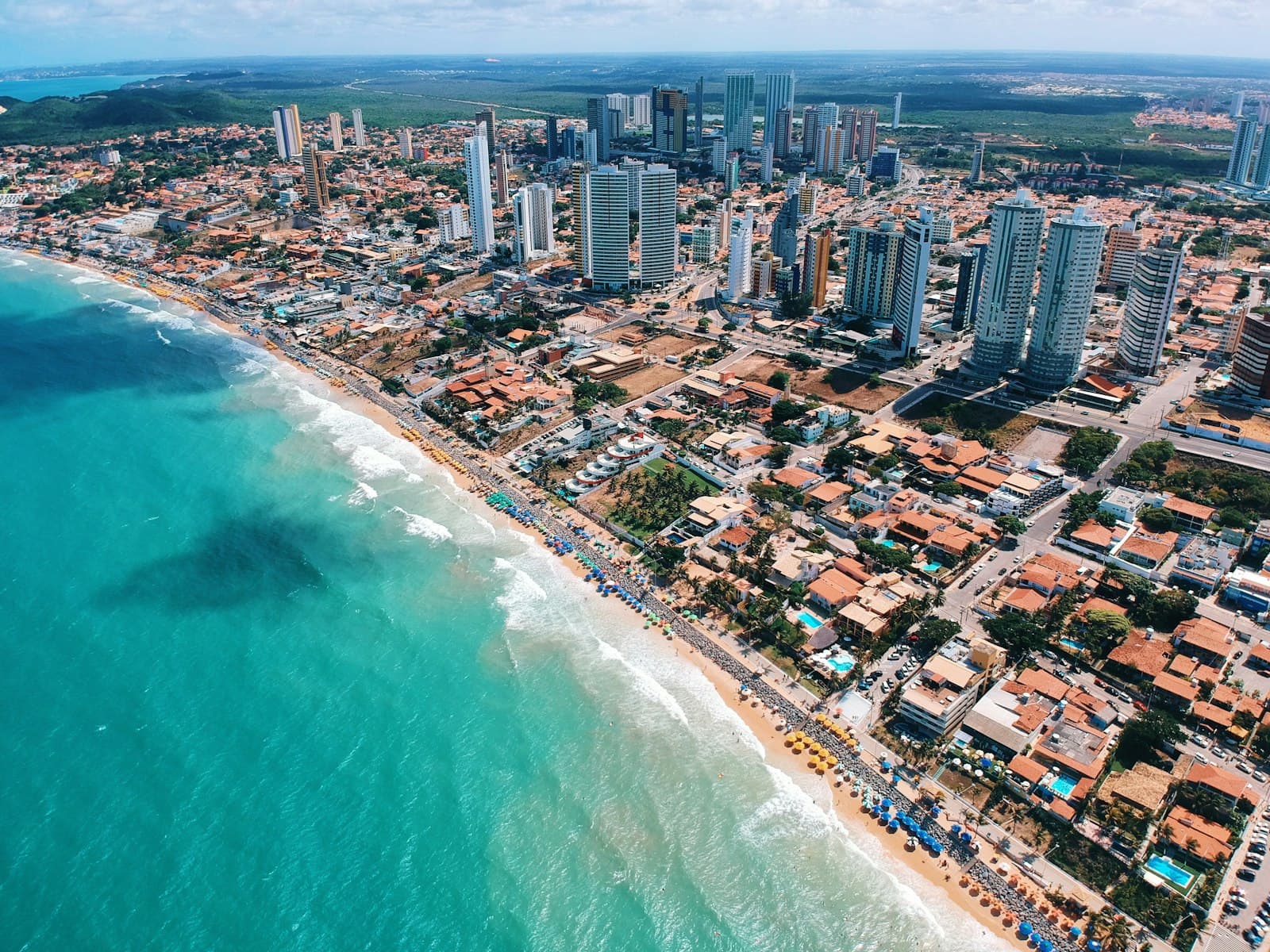 Pipa — aerial photography of city building near the seashore during daytime