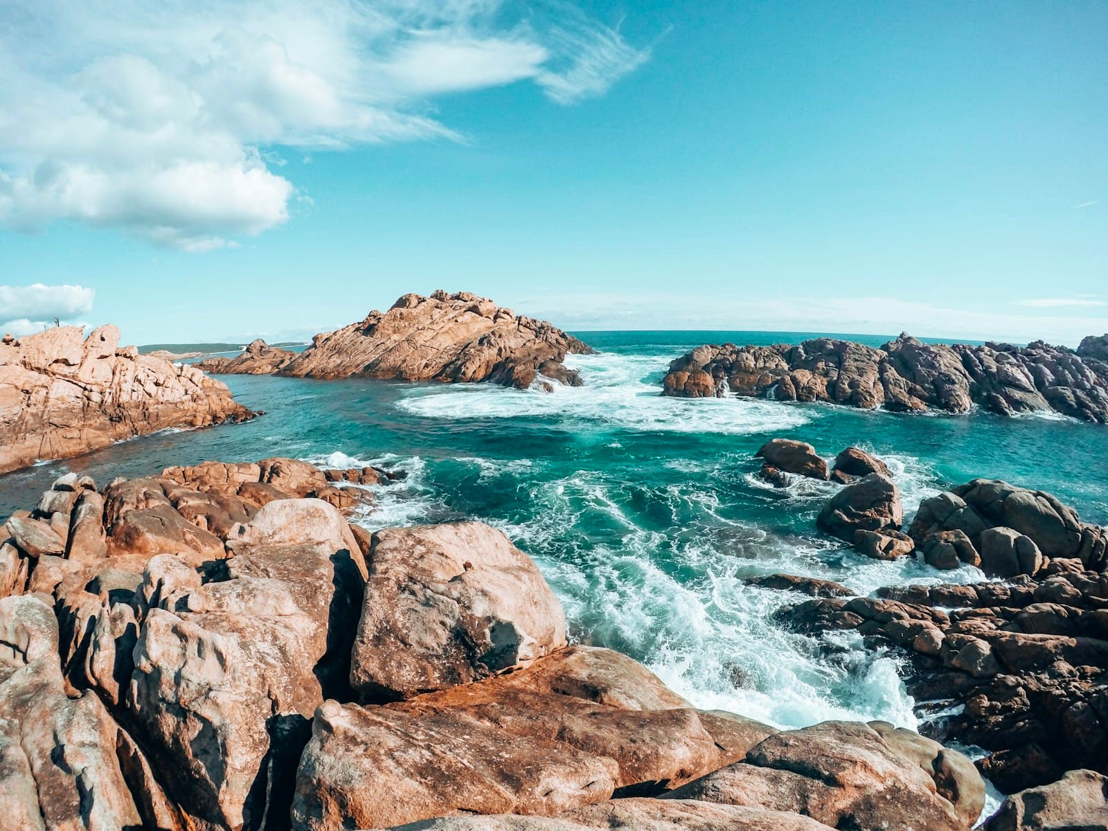 Port Lincoln — brown rocky mountain beside blue sea under blue sky during daytime