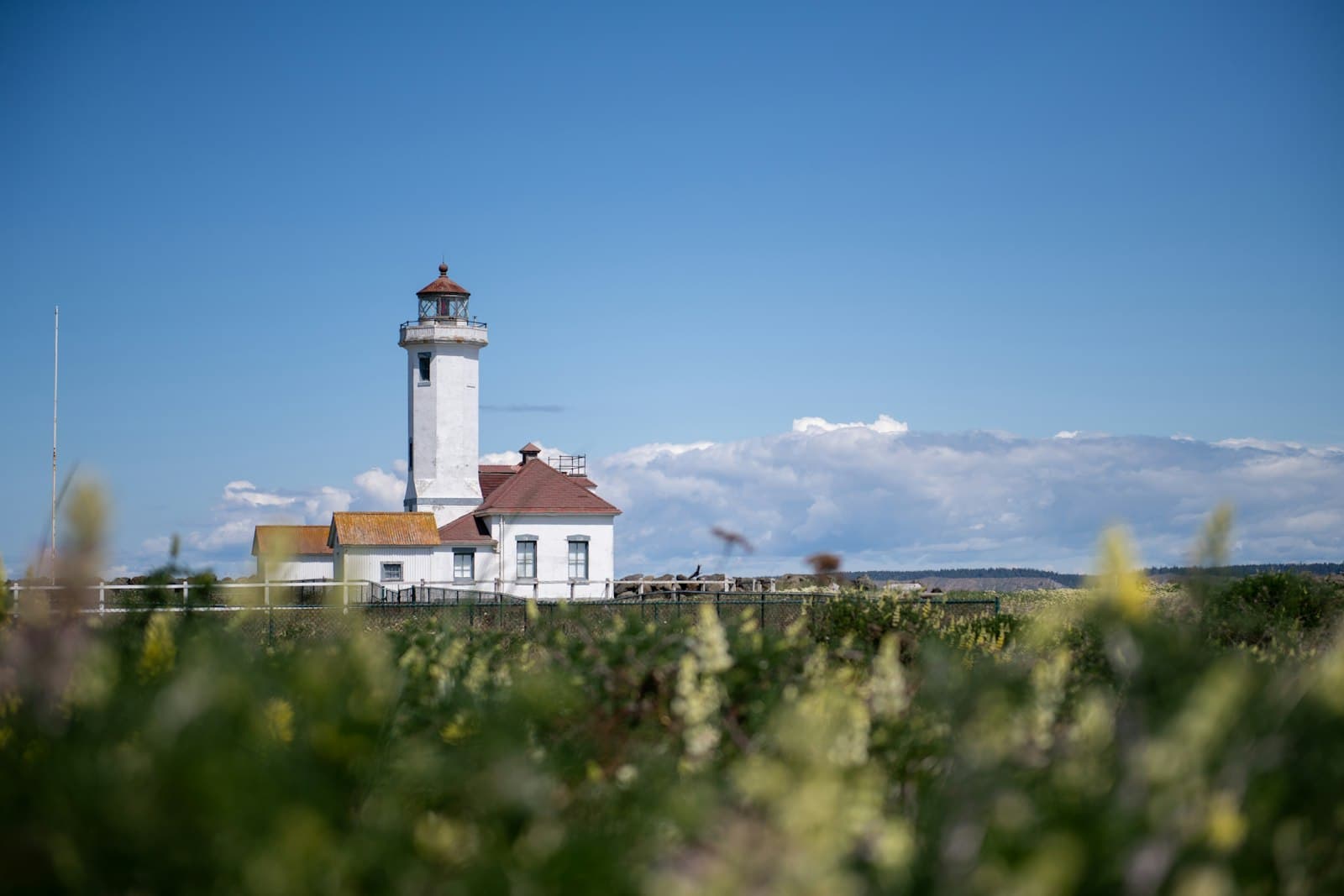 Port Townsend — White lighthouse on a hill under blue sky