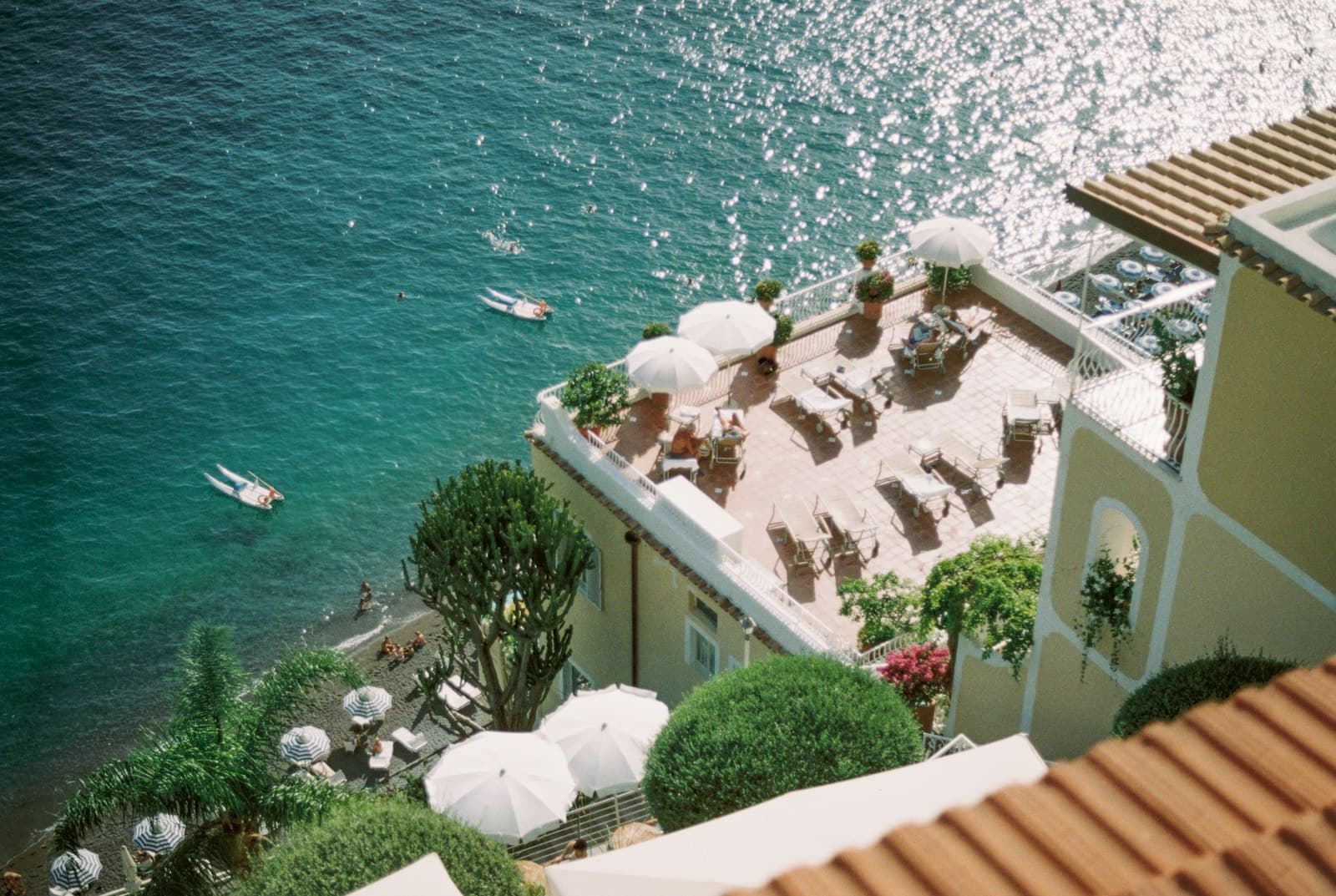 Positano — an aerial view of a beach with umbrellas and chairs
