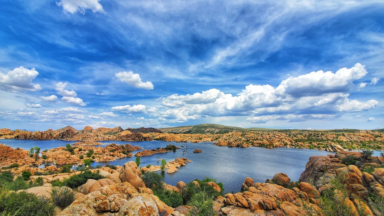 Prescott — brown rocks on body of water under blue sky and white clouds during daytime