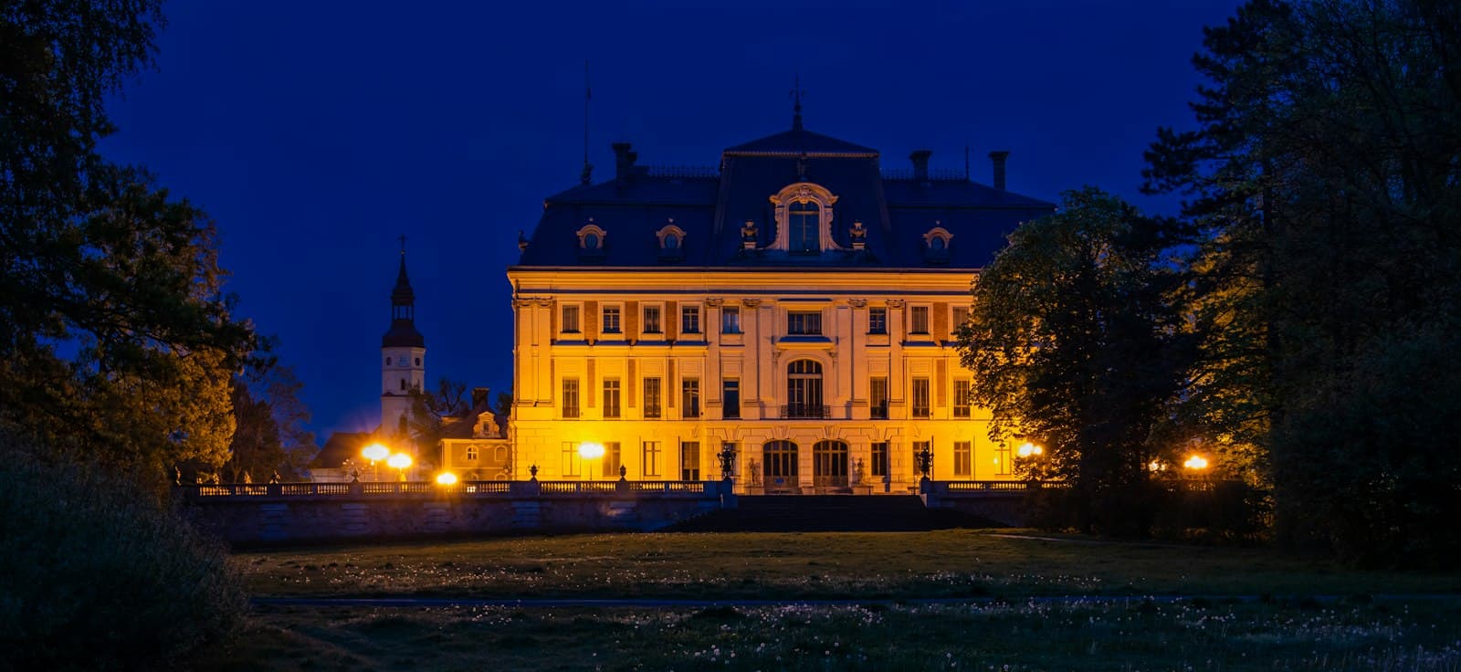 Pszczyna — white concrete building during night time