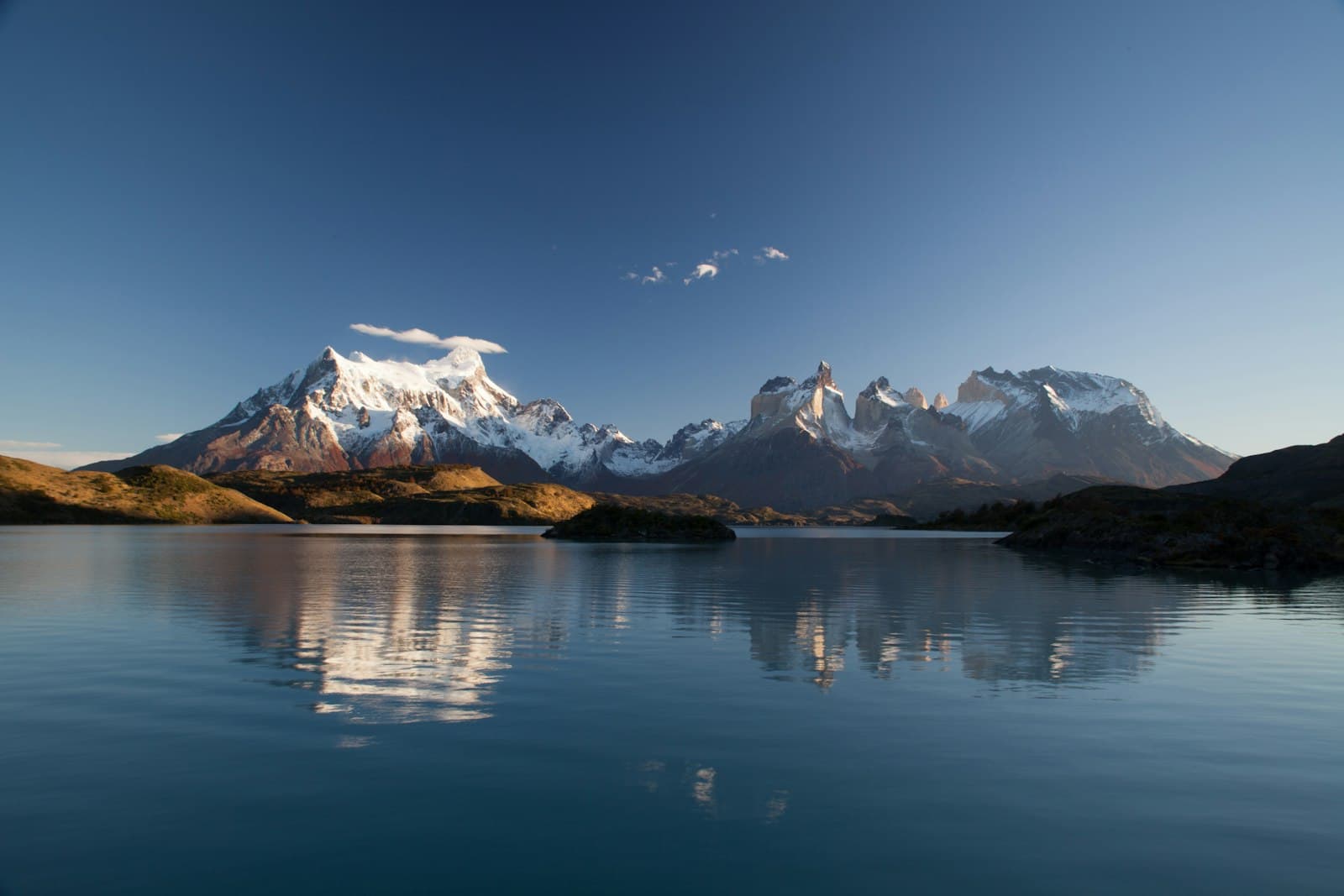 Pucón — snow covered mountain in reflective photography
