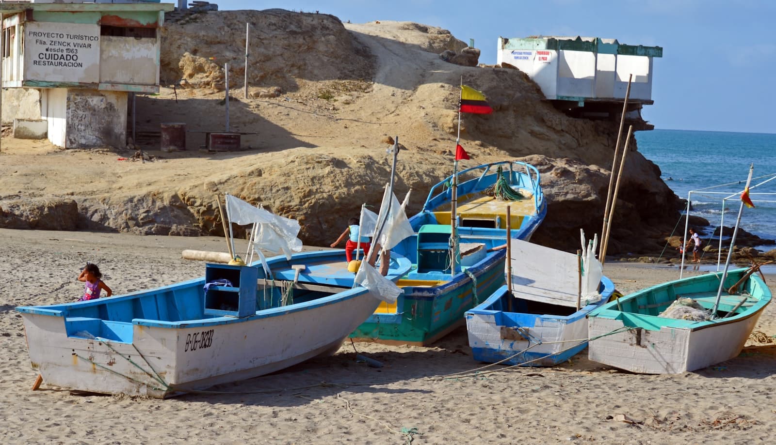 Puerto Ayora — a couple of boats sitting on top of a sandy beach