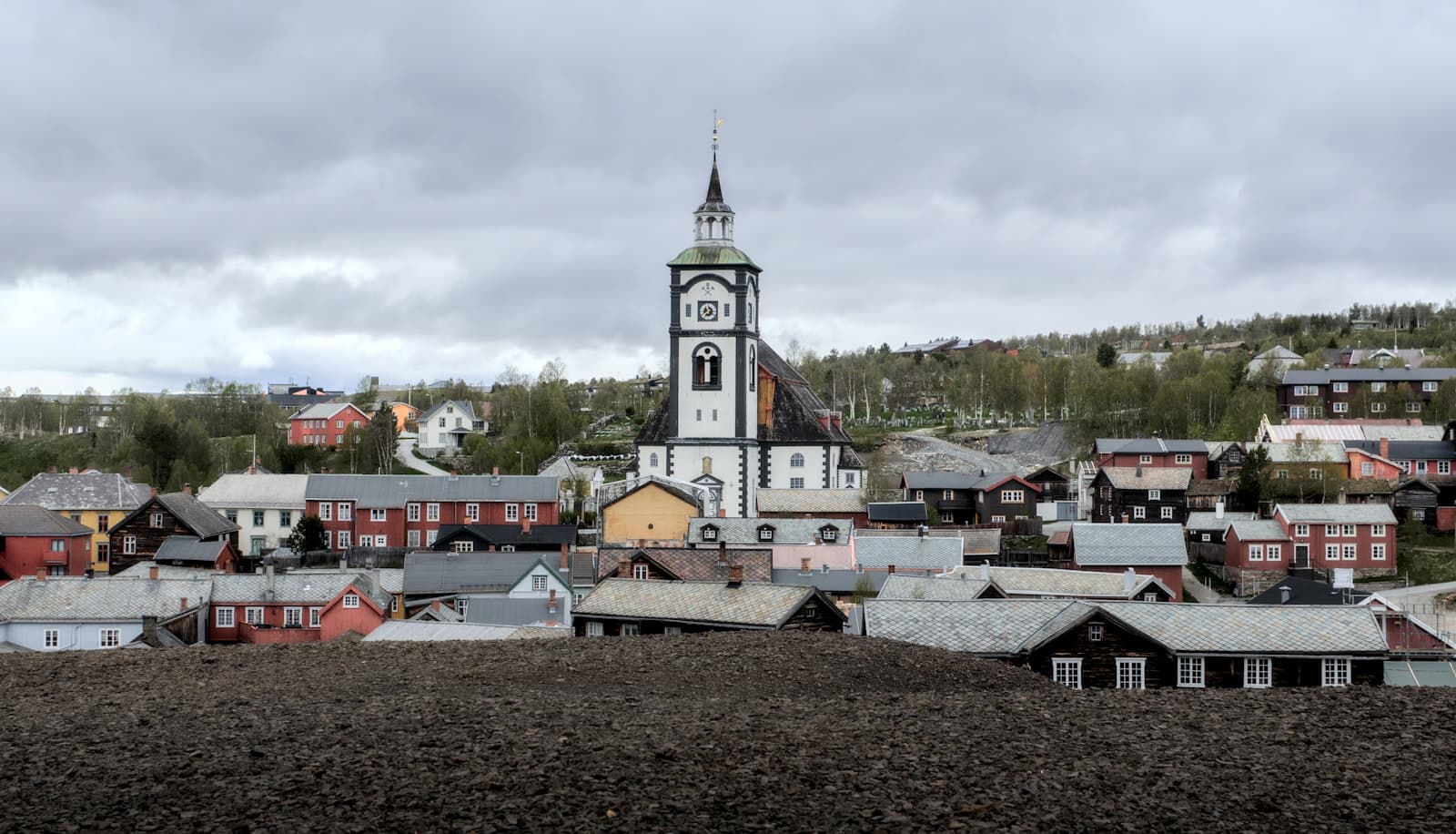 Røros — A town with a church under a cloudy sky.