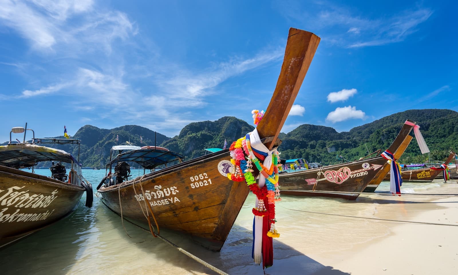 Ranong — person standing inside the brown boat parked on the seashore