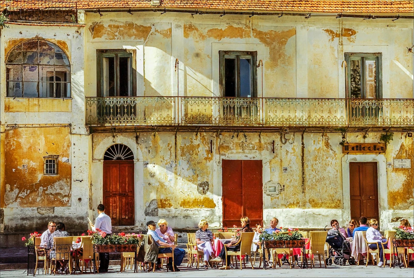 Ravello — people sitting on chairs near brown concrete building during daytime