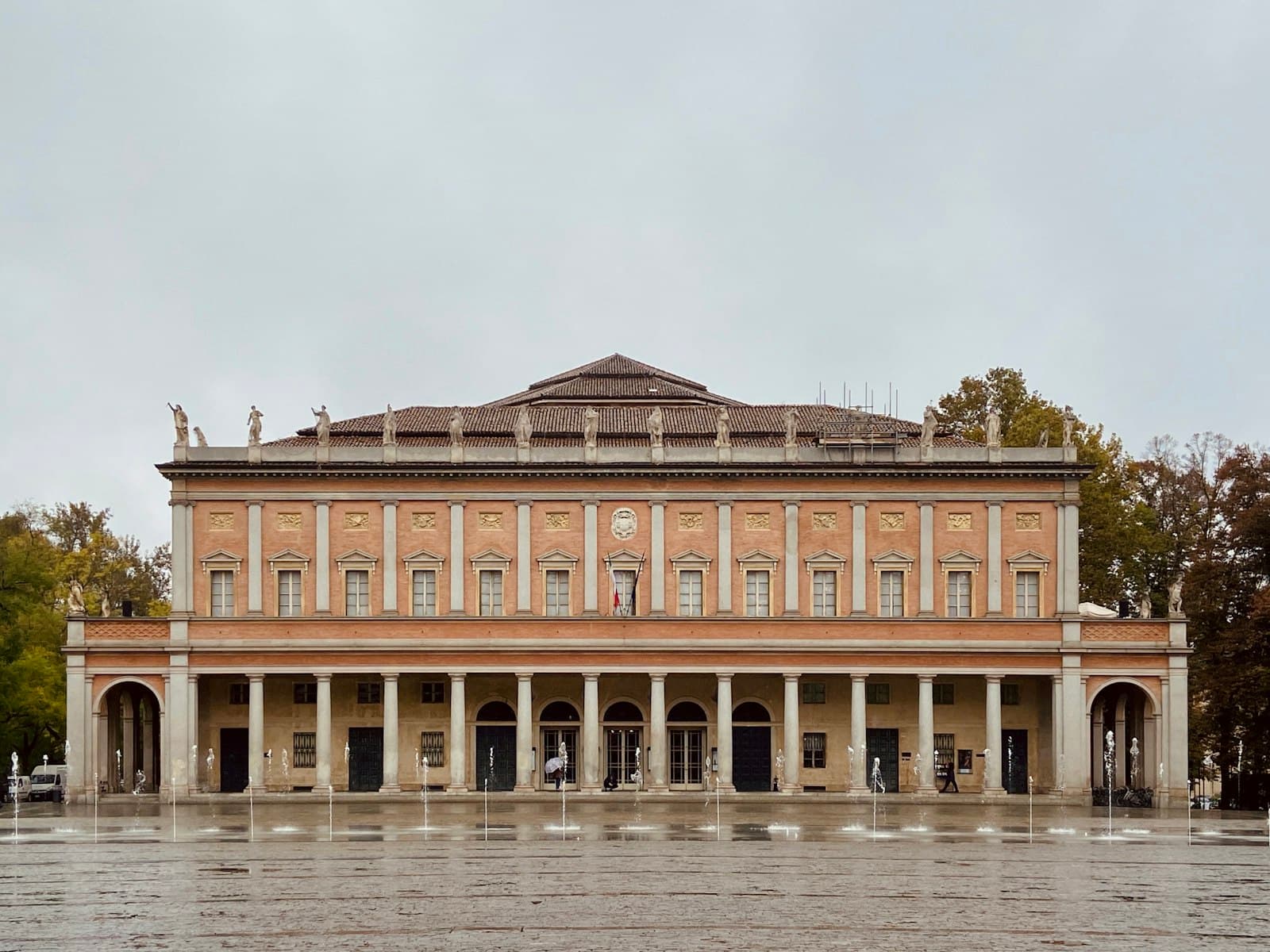 Reggio Emilia — brown concrete building near body of water during daytime