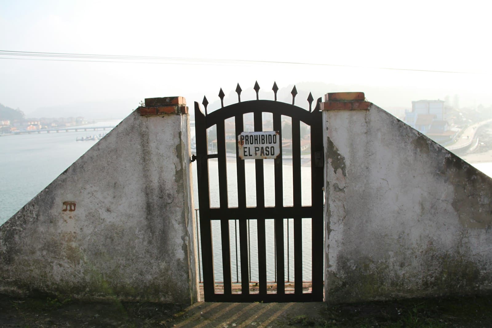 Ribadesella — brown wooden gate on gray concrete wall
