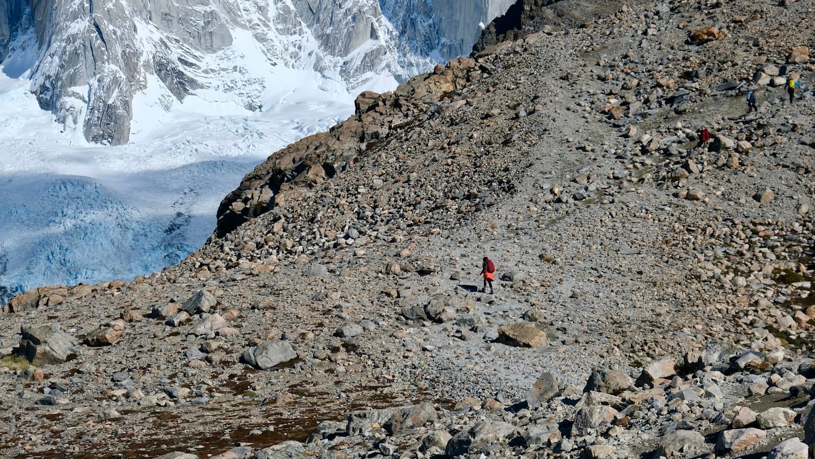 Río Gallegos — A lone hiker ascends a rocky mountain trail.