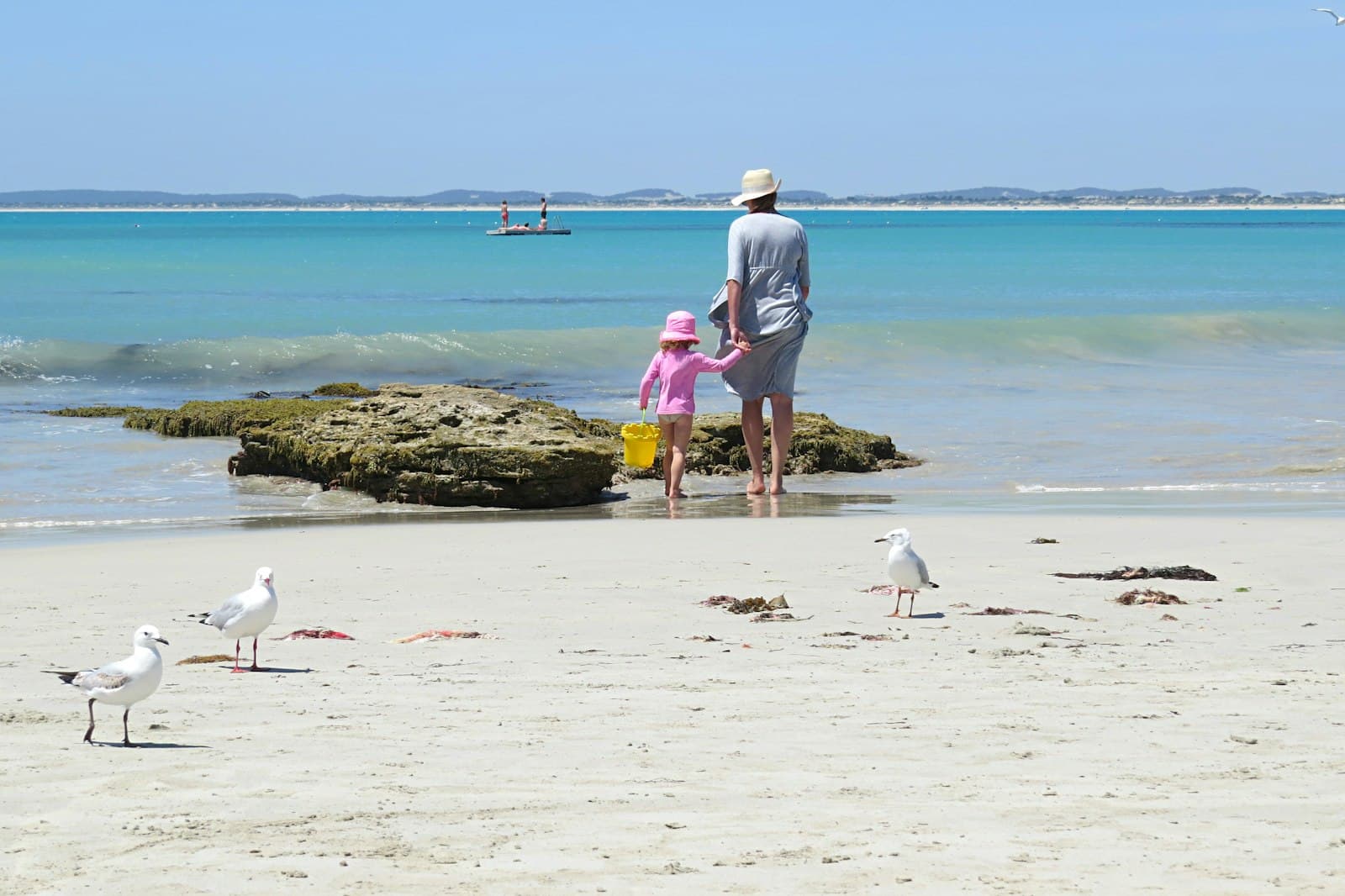 Robe — woman holding girl near beach during daytime