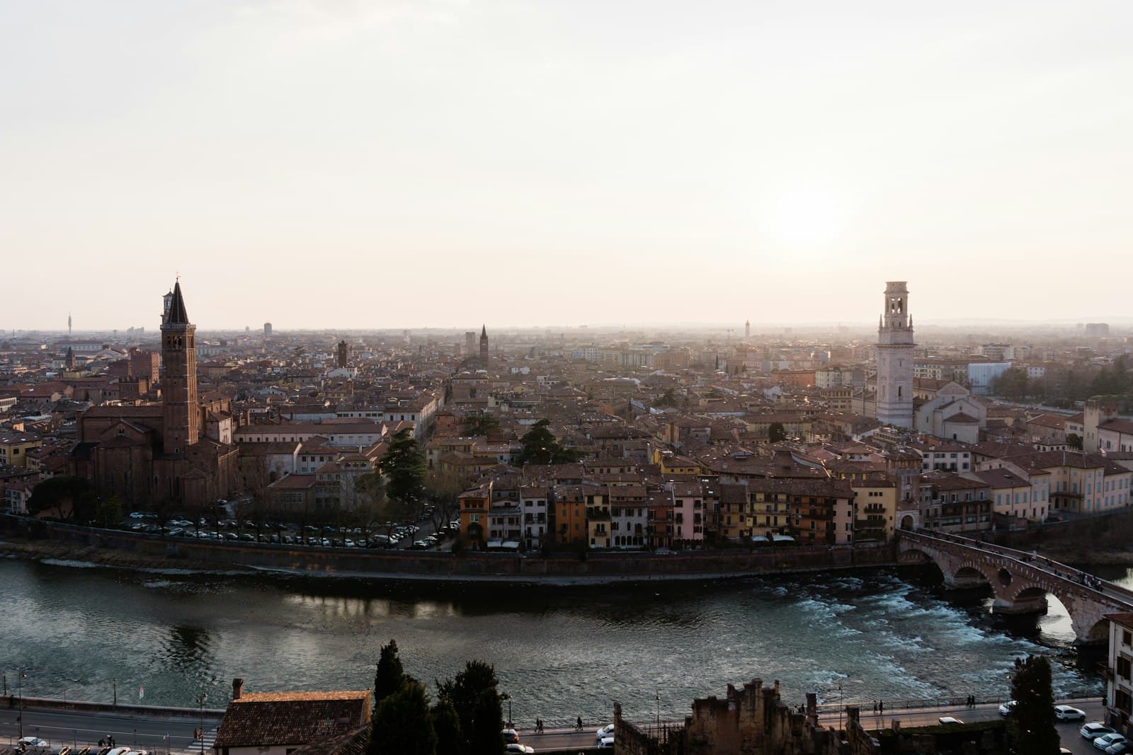Romeo & Juliet in Verona — a river running through a city next to a bridge