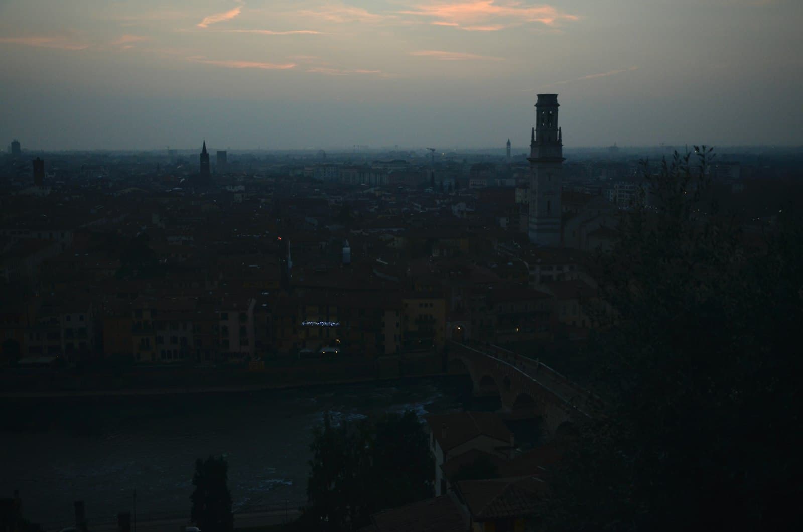 Romeo & Juliet in Verona — a view of a city with a clock tower in the distance