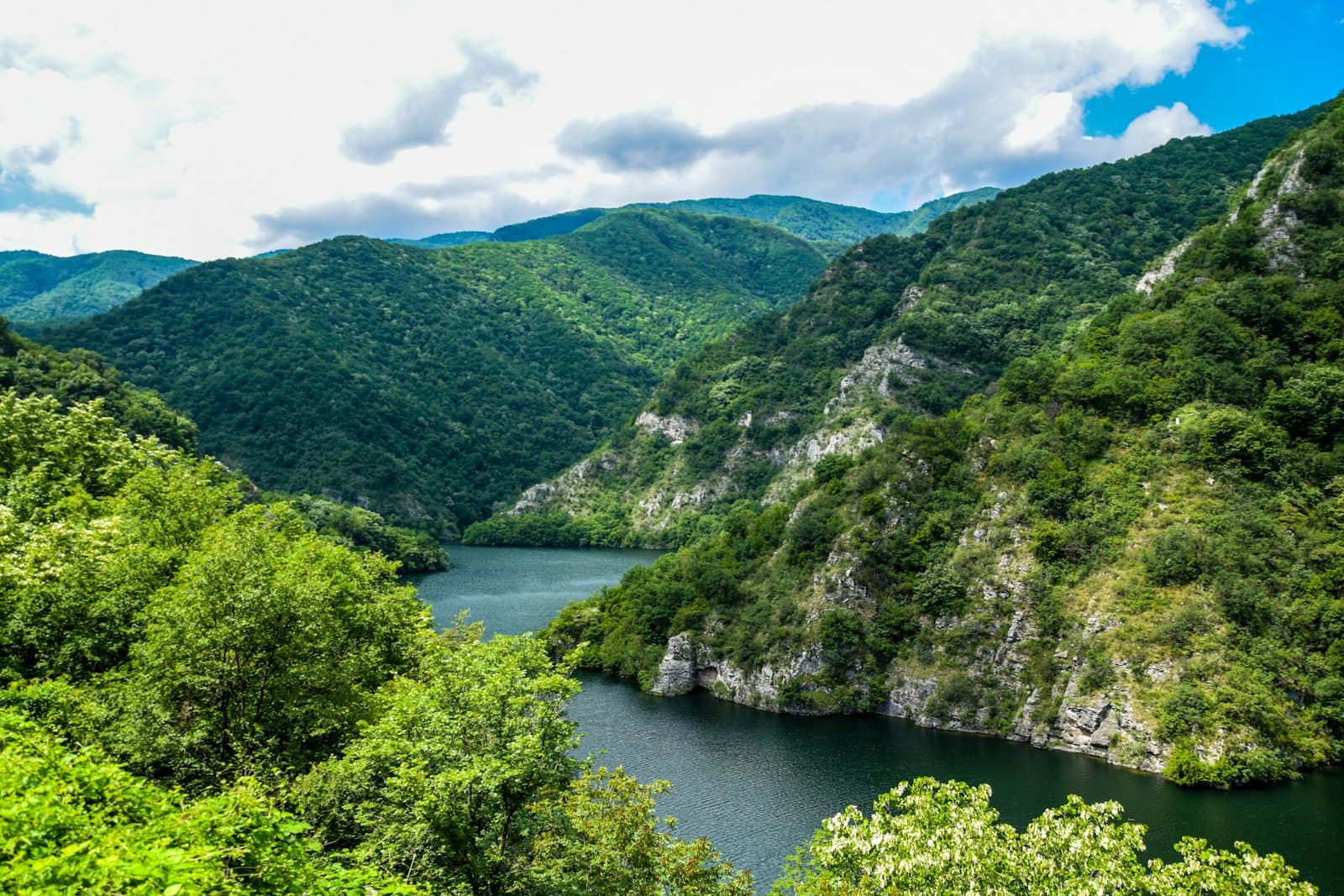 Roussé — green mountains beside river under blue sky during daytime