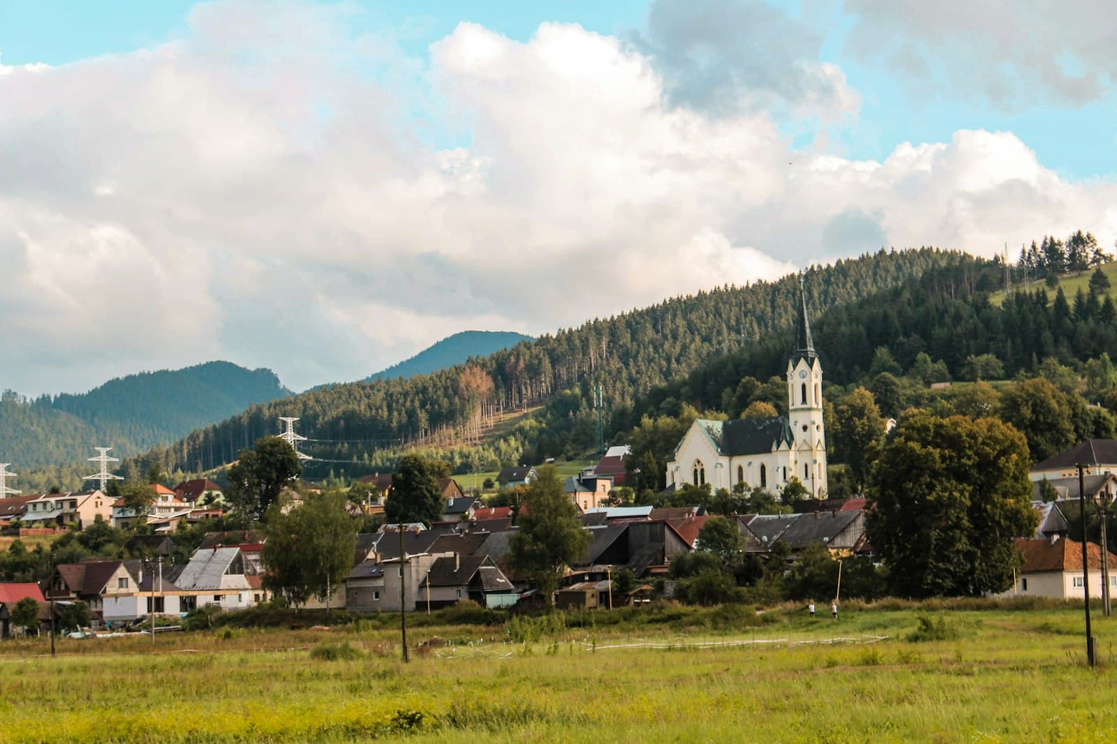 Ruzomberok — white and brown house near green trees and mountain under white clouds and blue sky during