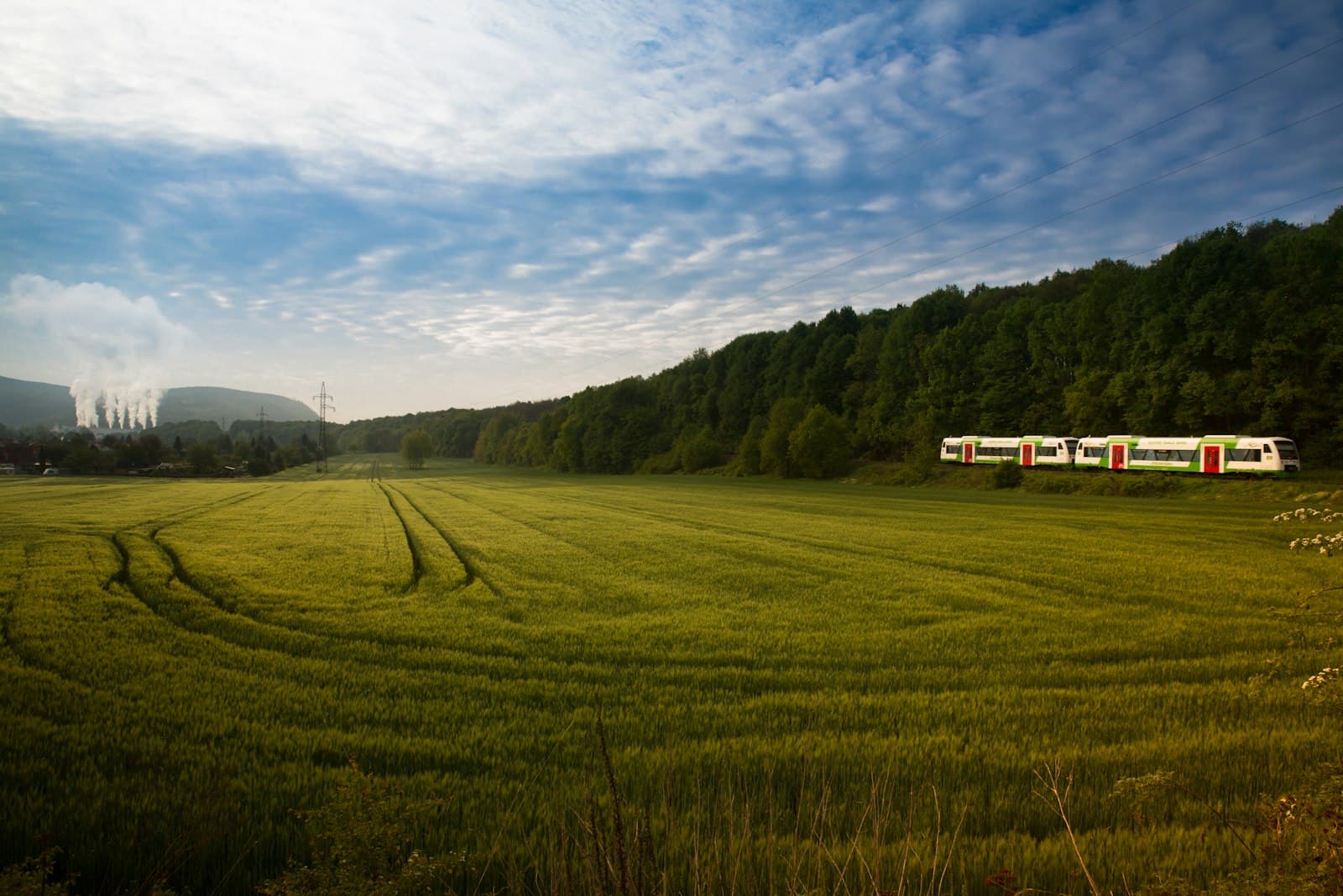 Saalfeld — grassland surrounded with trees near train tracks with train