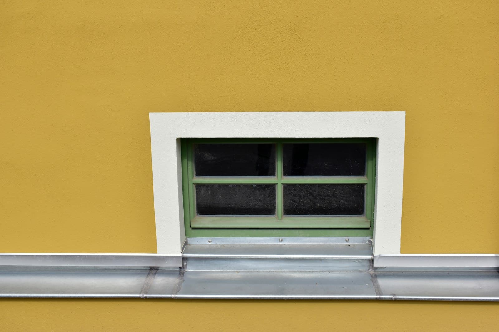 Saalfeld — a yellow building with a green window and a metal gutter