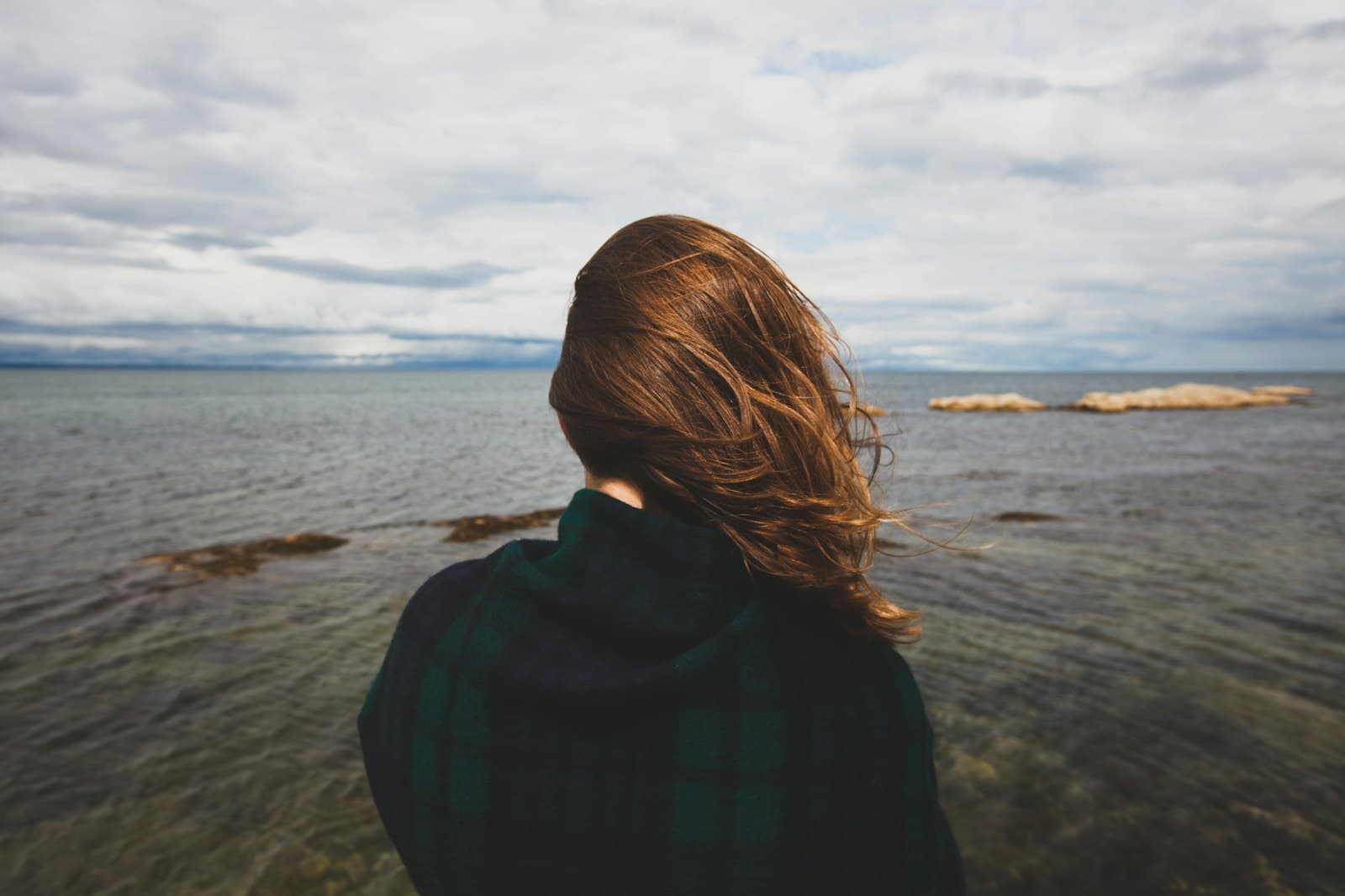 Saint Andrews — photography of woman standing near body of water during daytime