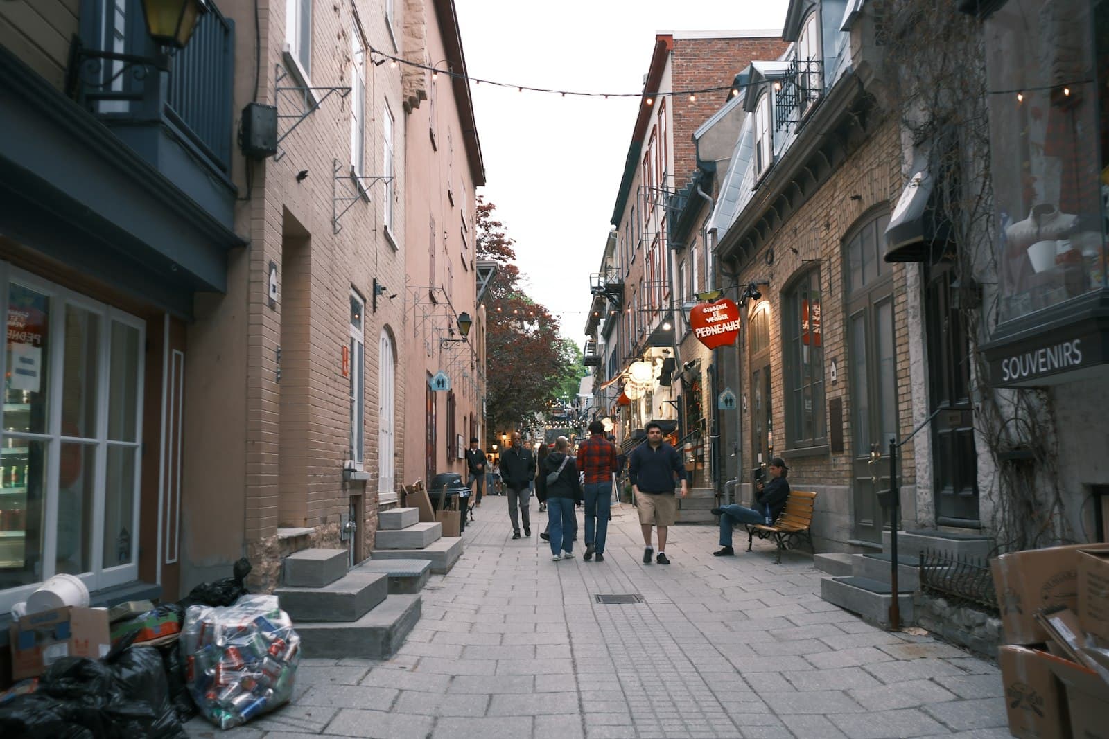 Saint-Jean-sur-Richelieu — People walking down a narrow, historic street with brick buildings.