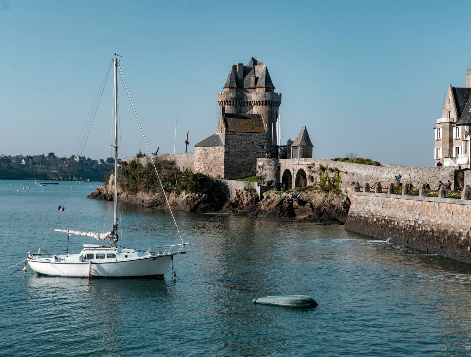 Saint-Lô — white boat on sea near brown concrete building during daytime