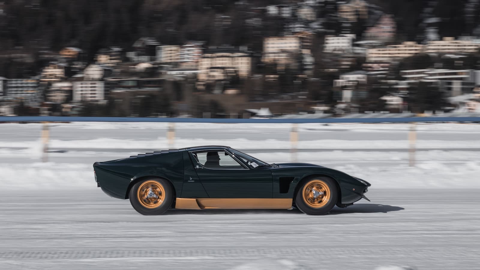 St. Moritz — A black sports car driving on a snowy road