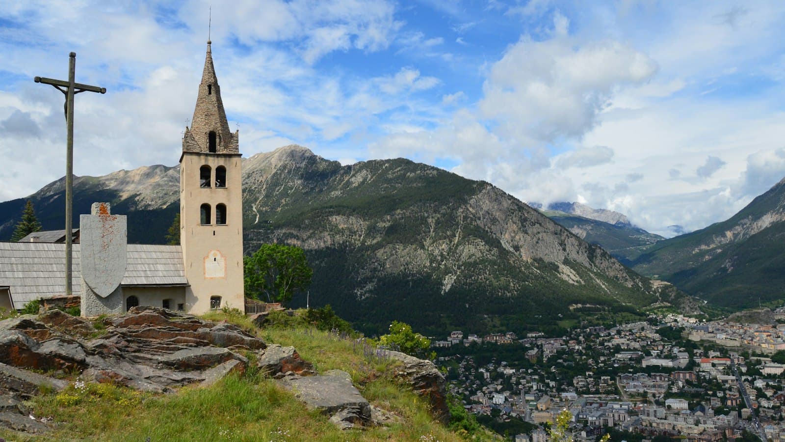 Saint-Pierre — A church on top of a hill with mountains in the background