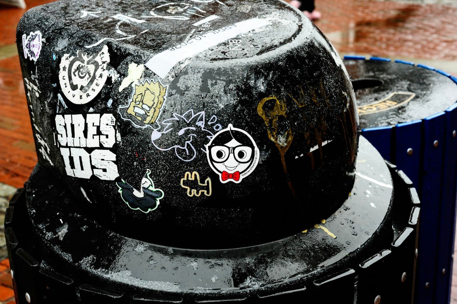 Salem — A black trash can covered in stickers