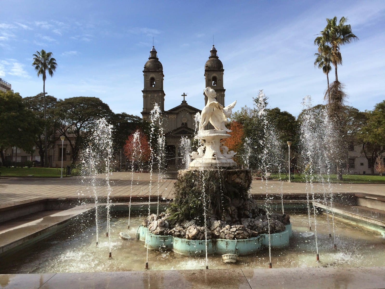 Salto — a fountain in front of a building with a clock tower in the background