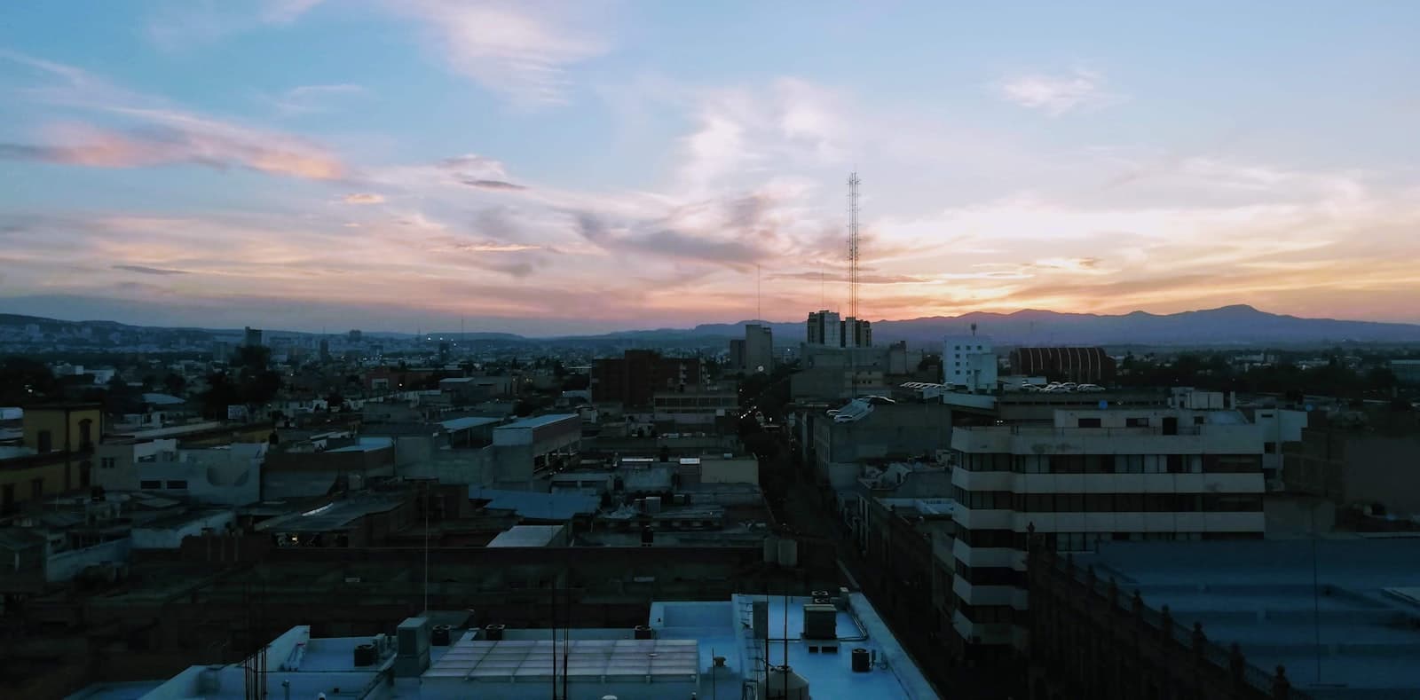 San Luis Potosí — a view of a city at sunset from a rooftop