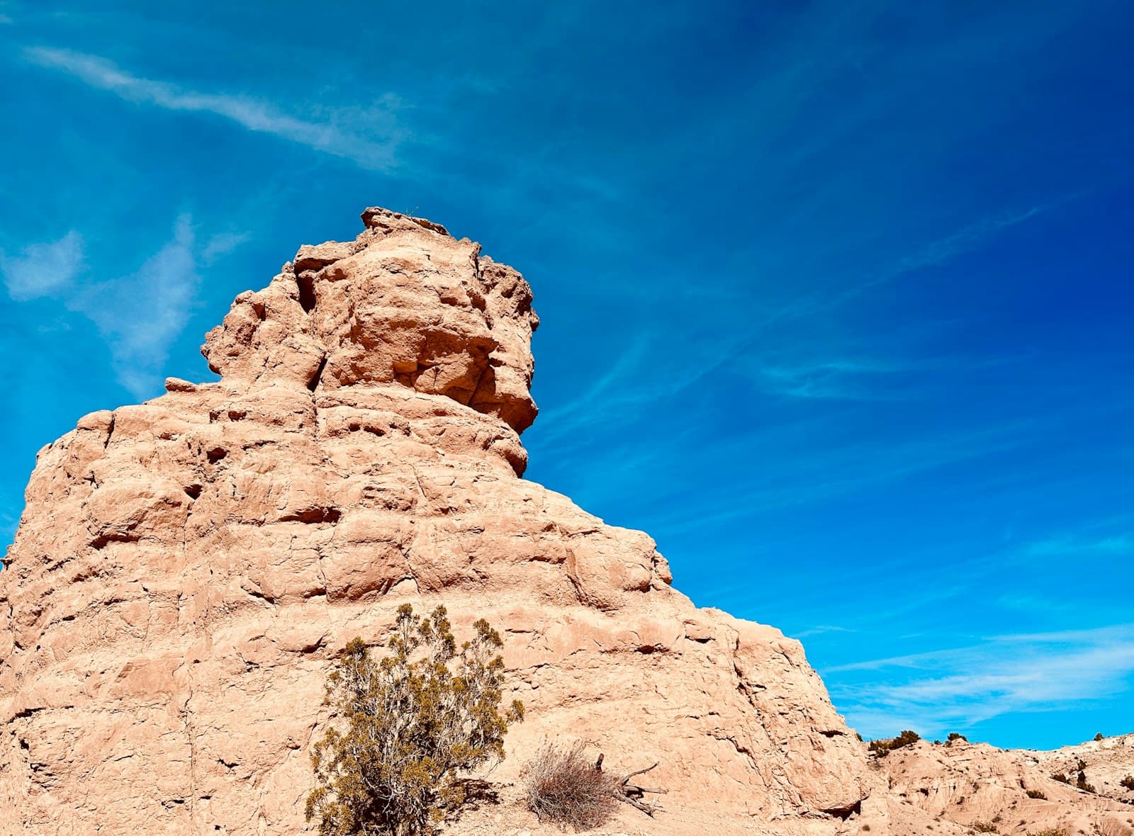 Santa Fe — A rock formation in the desert with a blue sky in the background