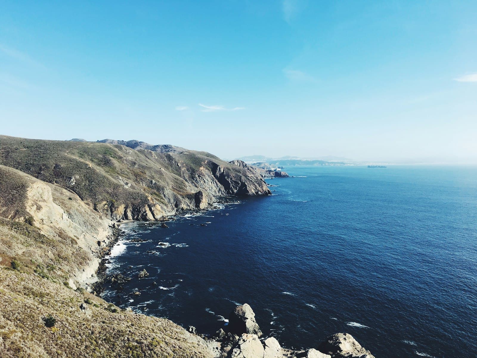 Sausalito — cliff beside ocean under clear blue sky during daytime