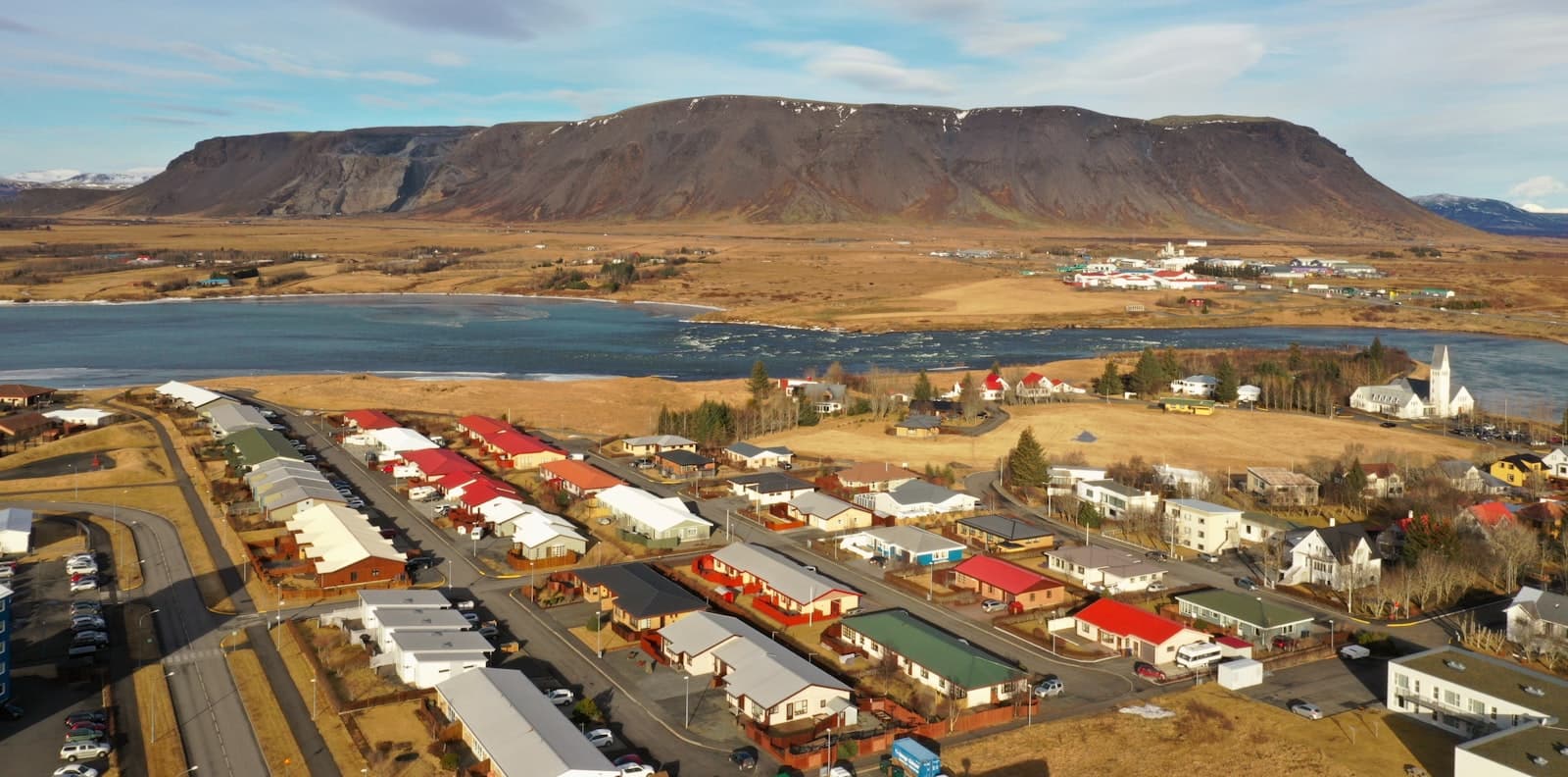 Selfoss — aerial view of city buildings near mountain during daytime