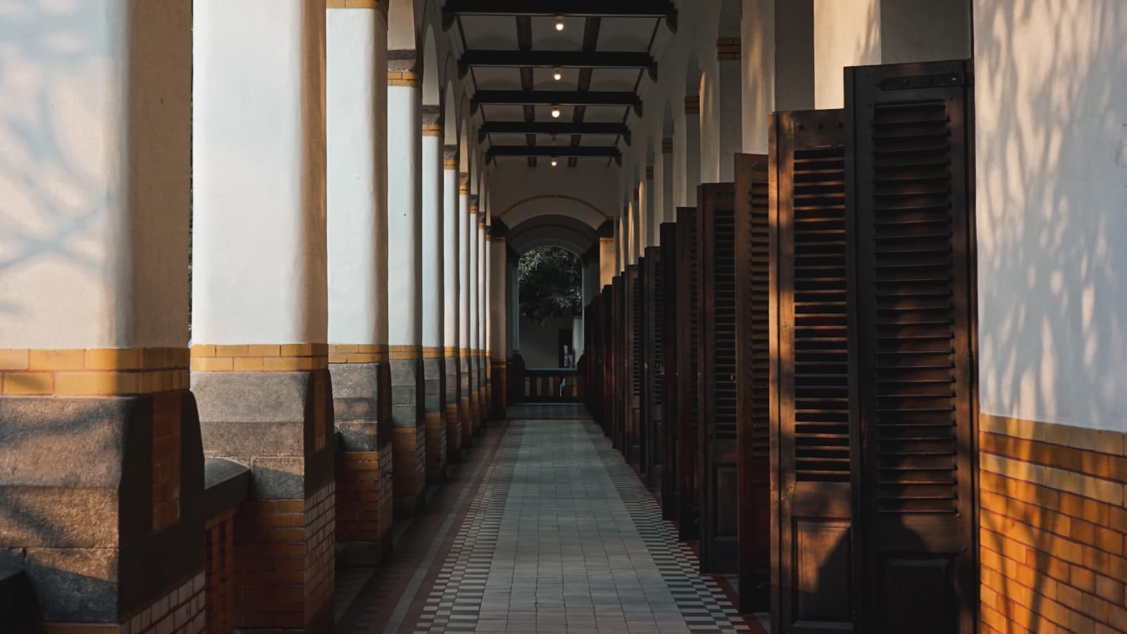 Semarang — a long hallway lined with wooden doors and windows
