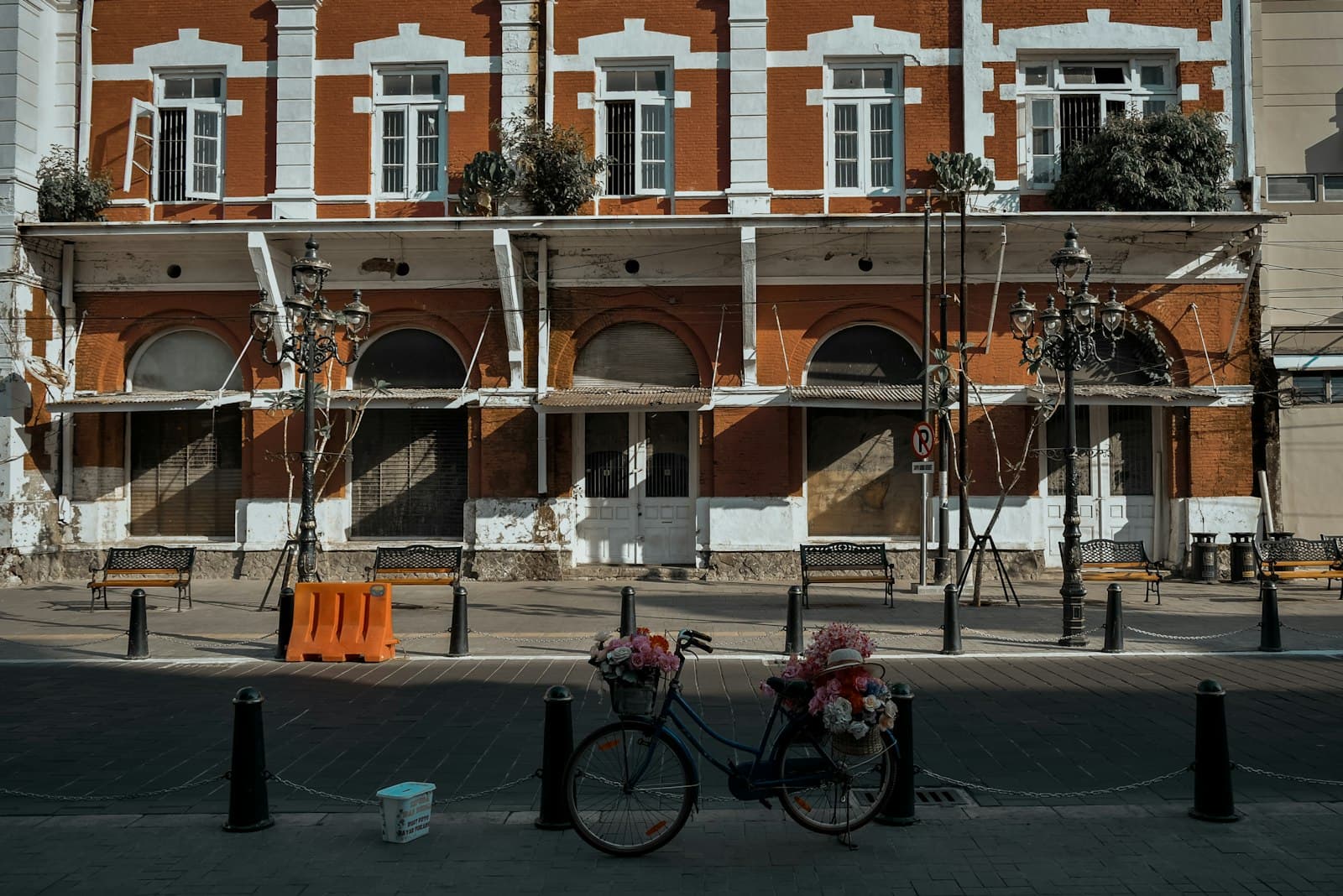 Semarang — black bicycle parked beside brown concrete building during daytime