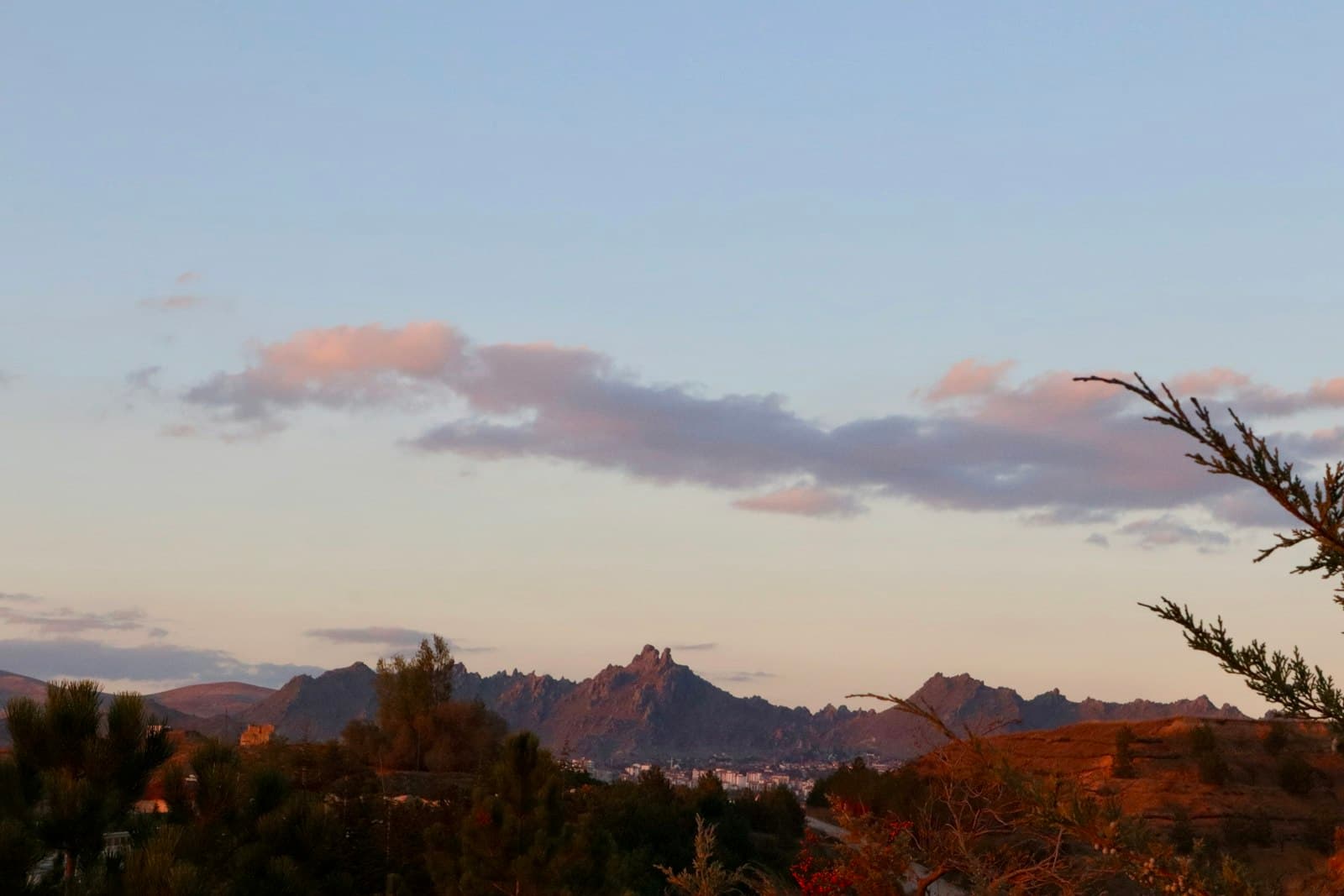 Sivrihisar — a landscape with trees and mountains in the background